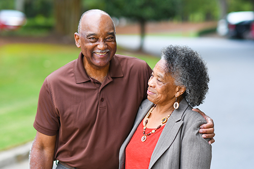 African American couple hugging and smiling together outside